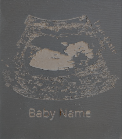 Sonogram engraved in painted wood